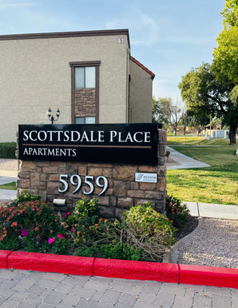 Building sign saying Scottsdale Place with a building and trees in the background